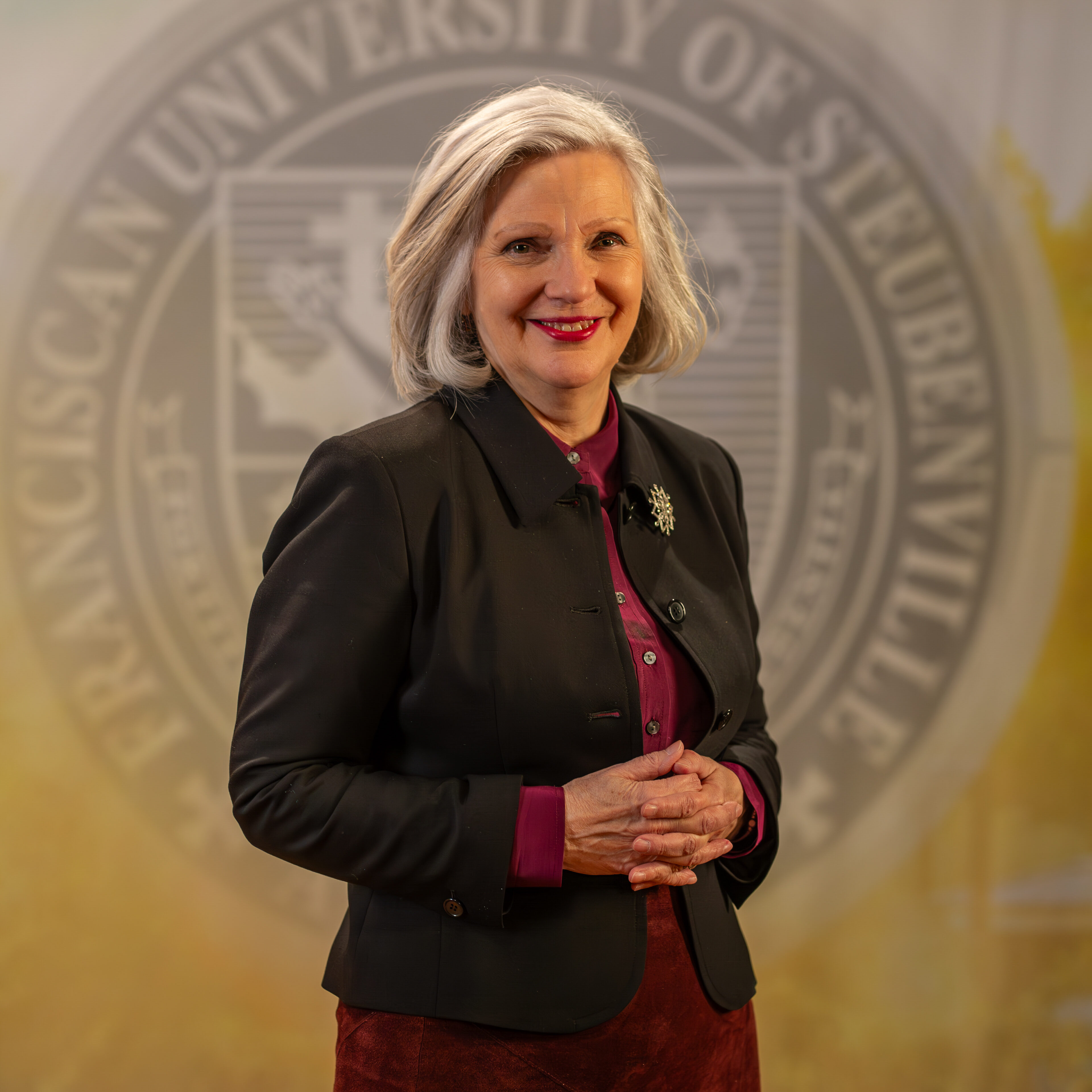 To Web – Jacqueline Leonard FEB2025 –2 Dr. Jacqueline Leonard standing in front of a university seal.